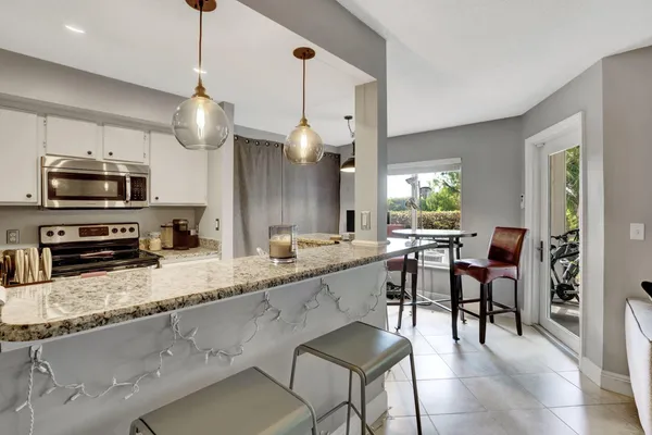 a kitchen with a sink stainless steel appliances and cabinets