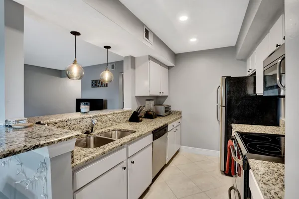 a bedroom with a bed and a large mirror