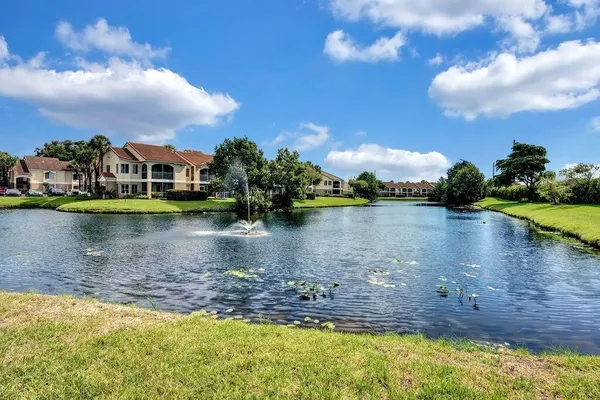 a view of a lake with houses in the back