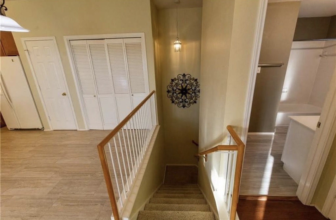 1900 Scofield Ridge Parkway, Unit 3101 Austin, TX 78727 - Photo 20 of 24 Carpeted staircase with a wood-finish handrail and white balusters