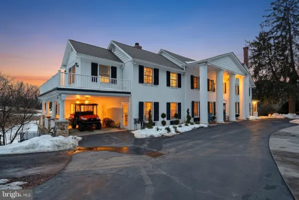 a view of a house with a yard covered with snow in the background