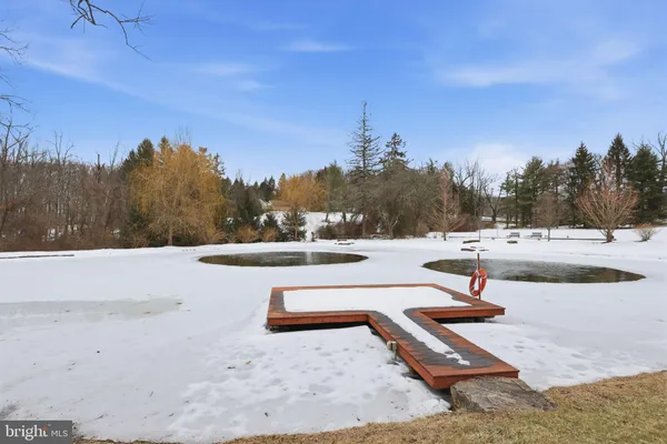 a kitchen with a dining table chairs and cabinets