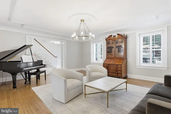 a dining room with furniture and a floor to ceiling window