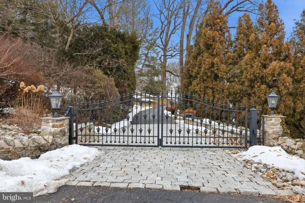 a view of a white house with a yard covered in snow