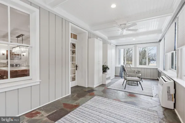 a living room with furniture rug and window