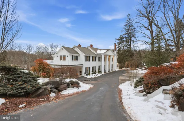 a white house that has a tree in front of it