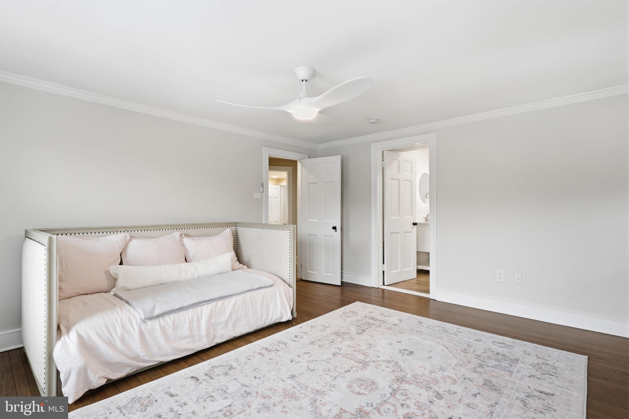 3039 Durham Road Doylestown, PA 18902 - Photo 63 of 122 a bedroom with a large bed and a chandelier