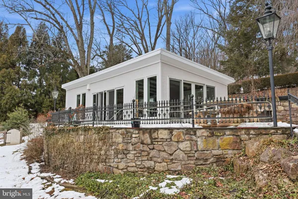 a living room with furniture a chandelier and a dining table