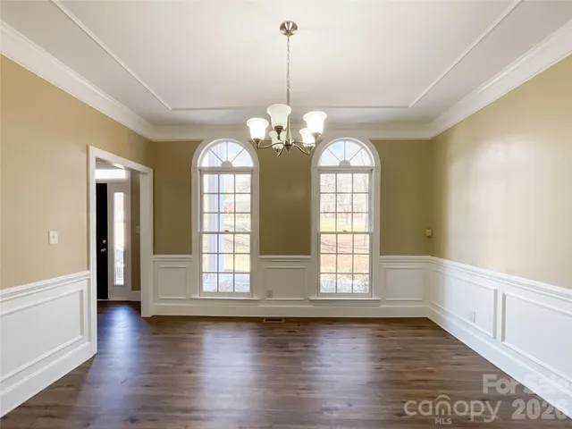 a view of a room with wooden floors