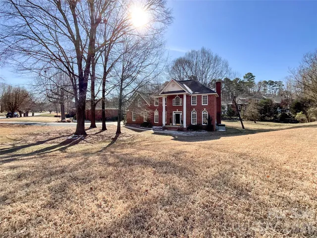 a front view of a house with a yard covered in snow