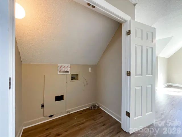 an empty room with wooden floor