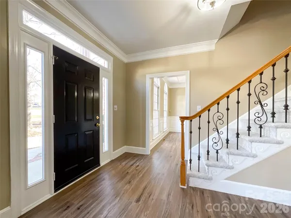 a view of entryway and hall with wooden floor