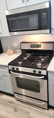 a stove top oven with granite countertops