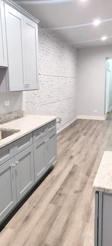 a view of a kitchen with white cabinets