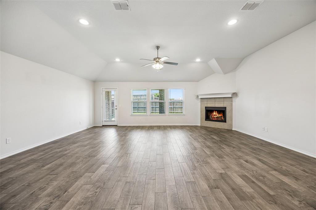 3807 Dogwood Road Melissa, TX 75454 - Photo 14 of 38 an empty room with windows and a fireplace