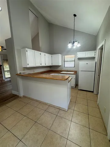 a kitchen with stainless steel appliances a sink a stove a refrigerator and cabinets
