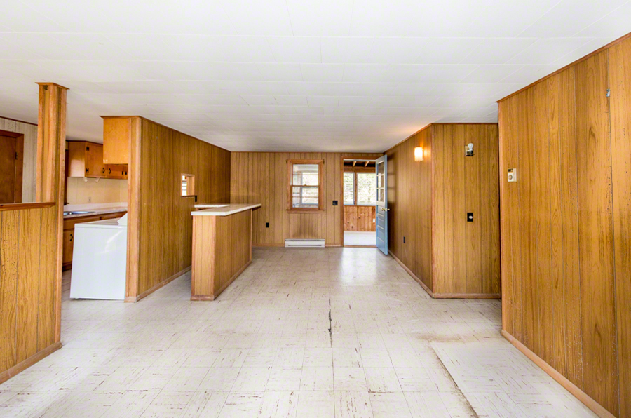 50 County Road Oak Bluffs, MA 02557 - Photo 5 of 14 a view of a kitchen with a refrigerator and wooden cabinets