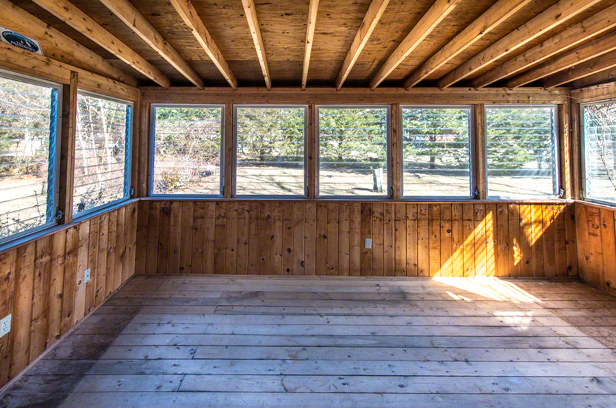 50 County Road Oak Bluffs, MA 02557 - Photo 6 of 14 a view of an empty room with wooden floor and a window