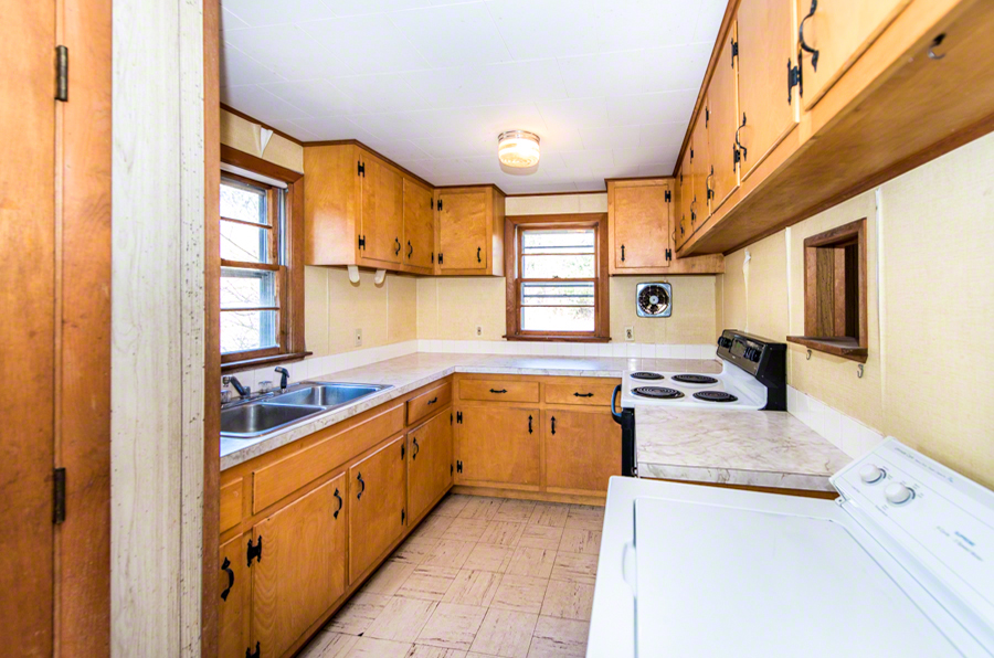 50 County Road Oak Bluffs, MA 02557 - Photo 7 of 14 a kitchen with stainless steel appliances granite countertop a sink and a stove next to a window