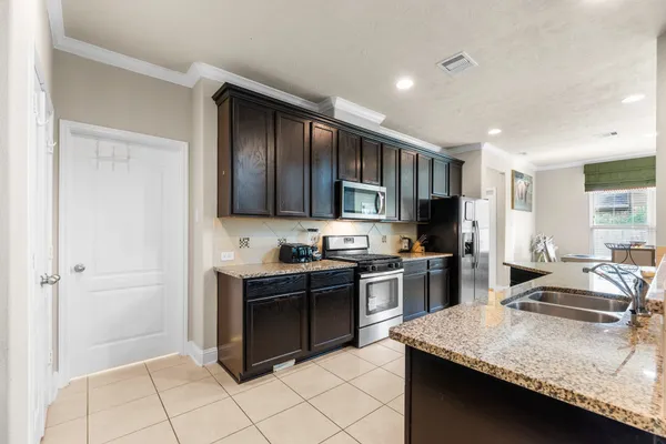 a bathroom with a granite countertop sink a toilet and shower