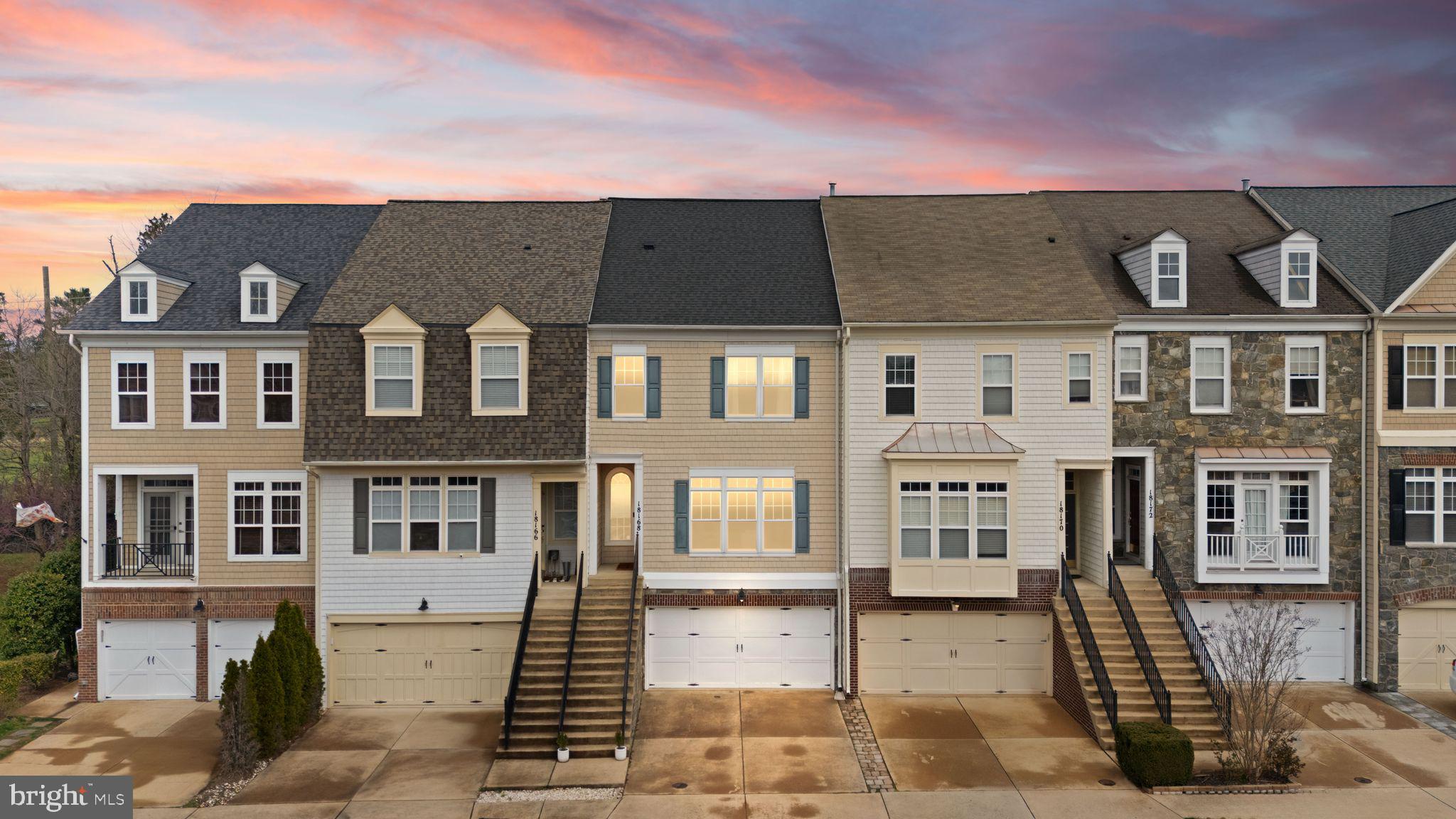 18168 Mill House Square Leesburg, VA 20176 - Photo 1 of 60 a front view of a residential apartment building with a yard
