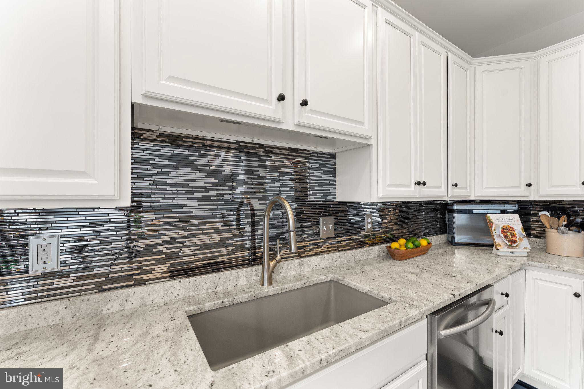 18168 Mill House Square Leesburg, VA 20176 - Photo 16 of 60 a kitchen with a sink and cabinets