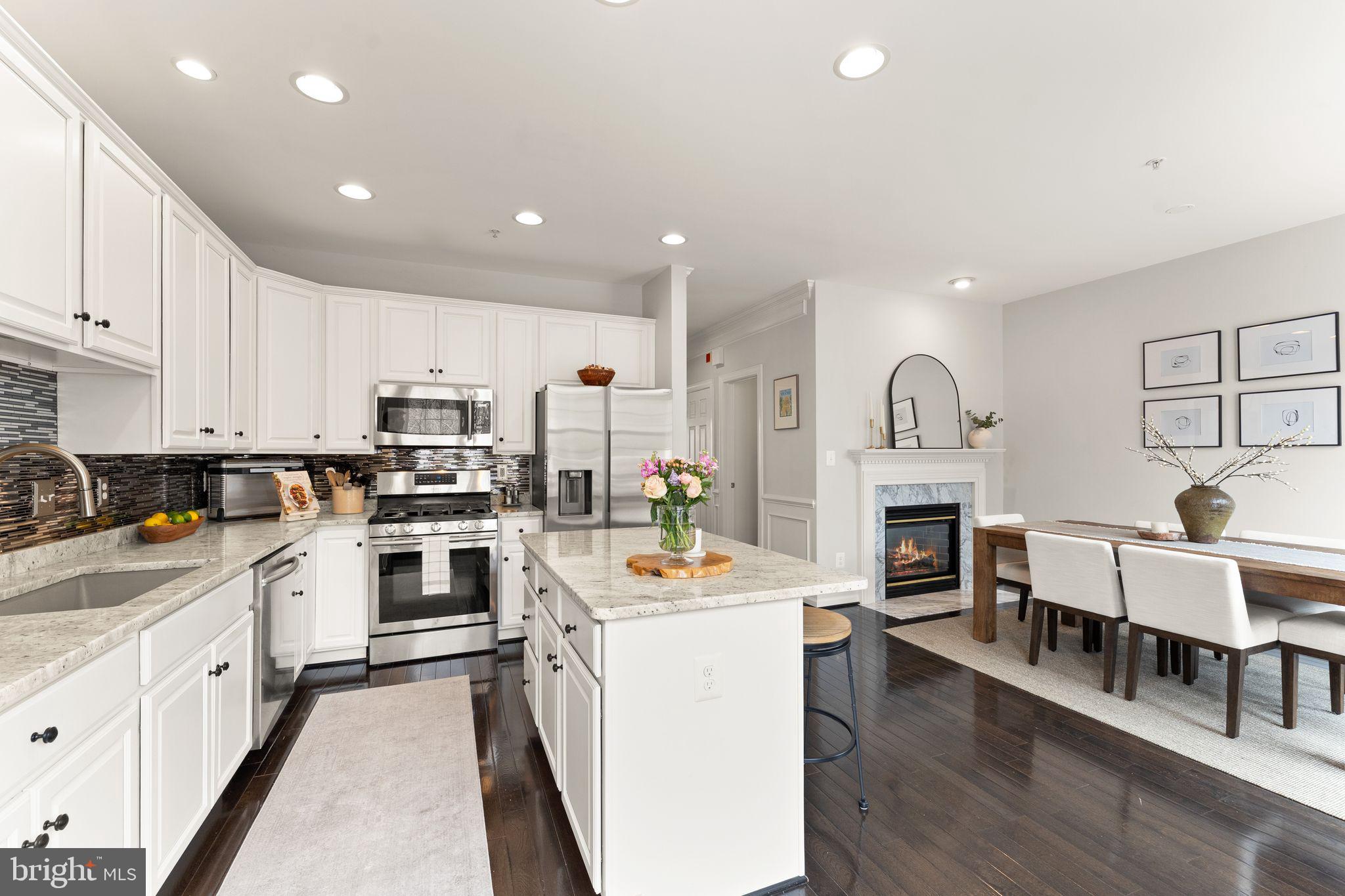 18168 Mill House Square Leesburg, VA 20176 - Photo 18 of 60 a kitchen with white cabinets and appliances