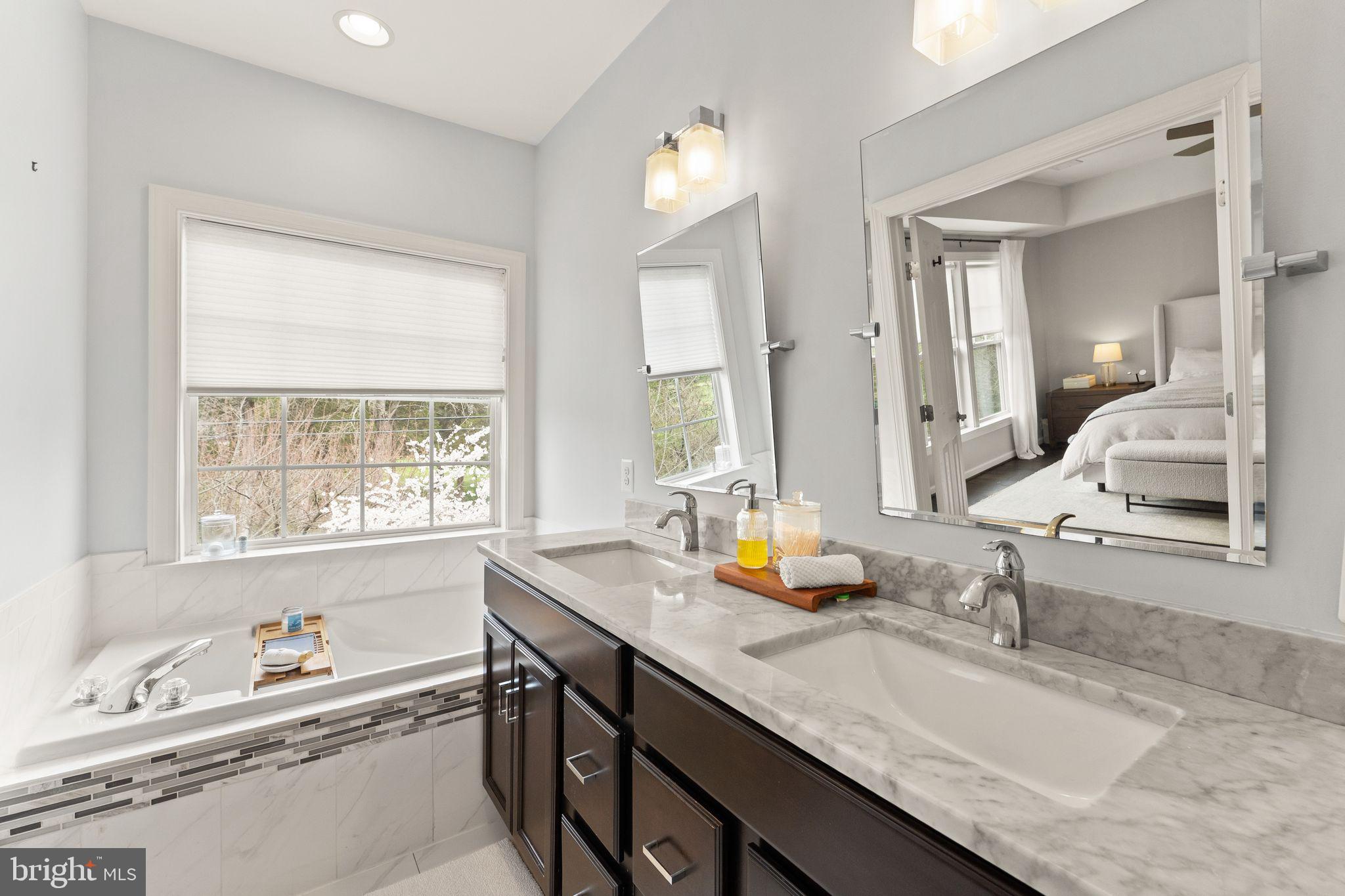 18168 Mill House Square Leesburg, VA 20176 - Photo 27 of 60 a bathroom with double vanity sinks and a bathtub
