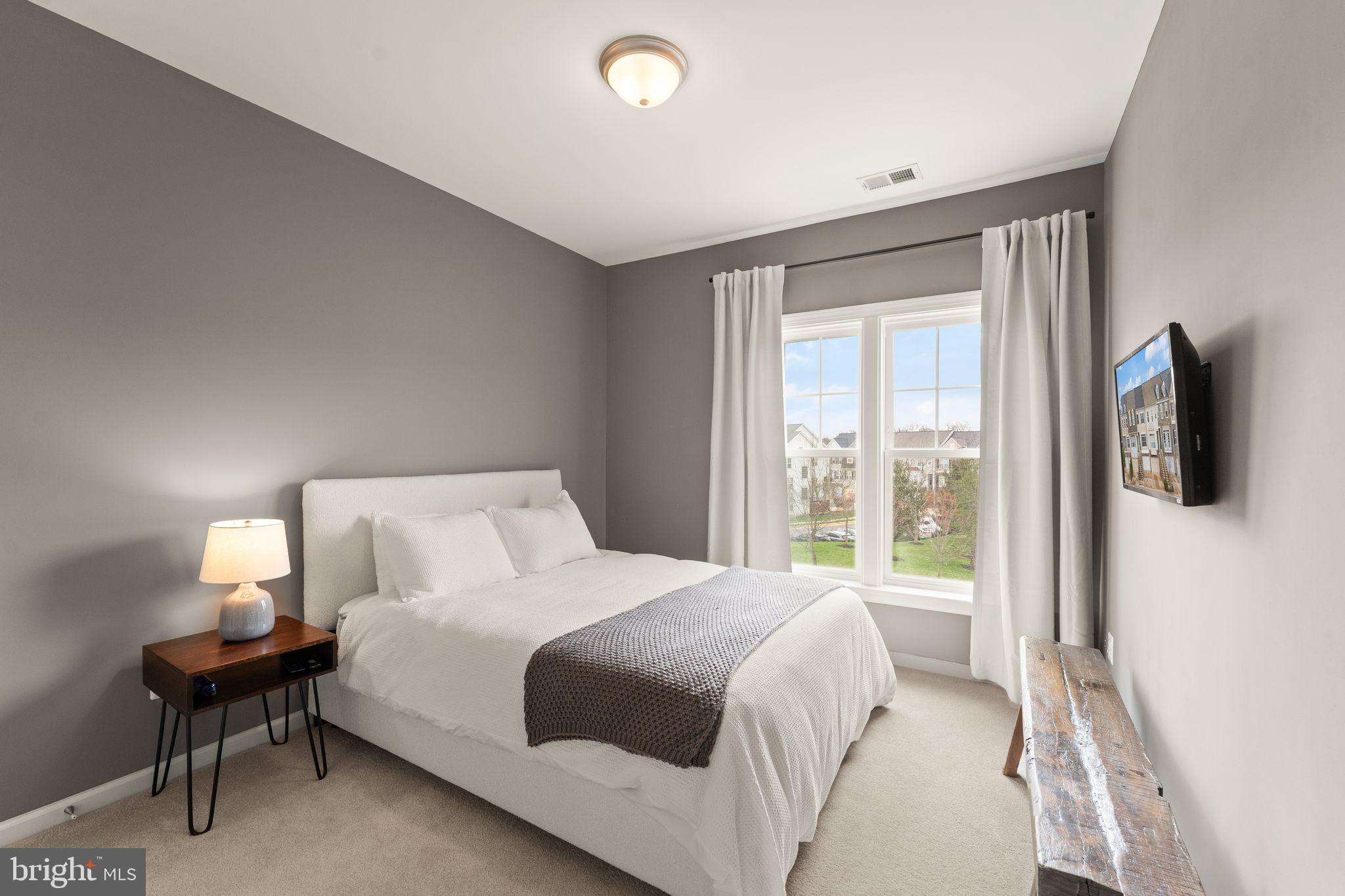 18168 Mill House Square Leesburg, VA 20176 - Photo 29 of 60 a bedroom with a bed and a flat screen tv