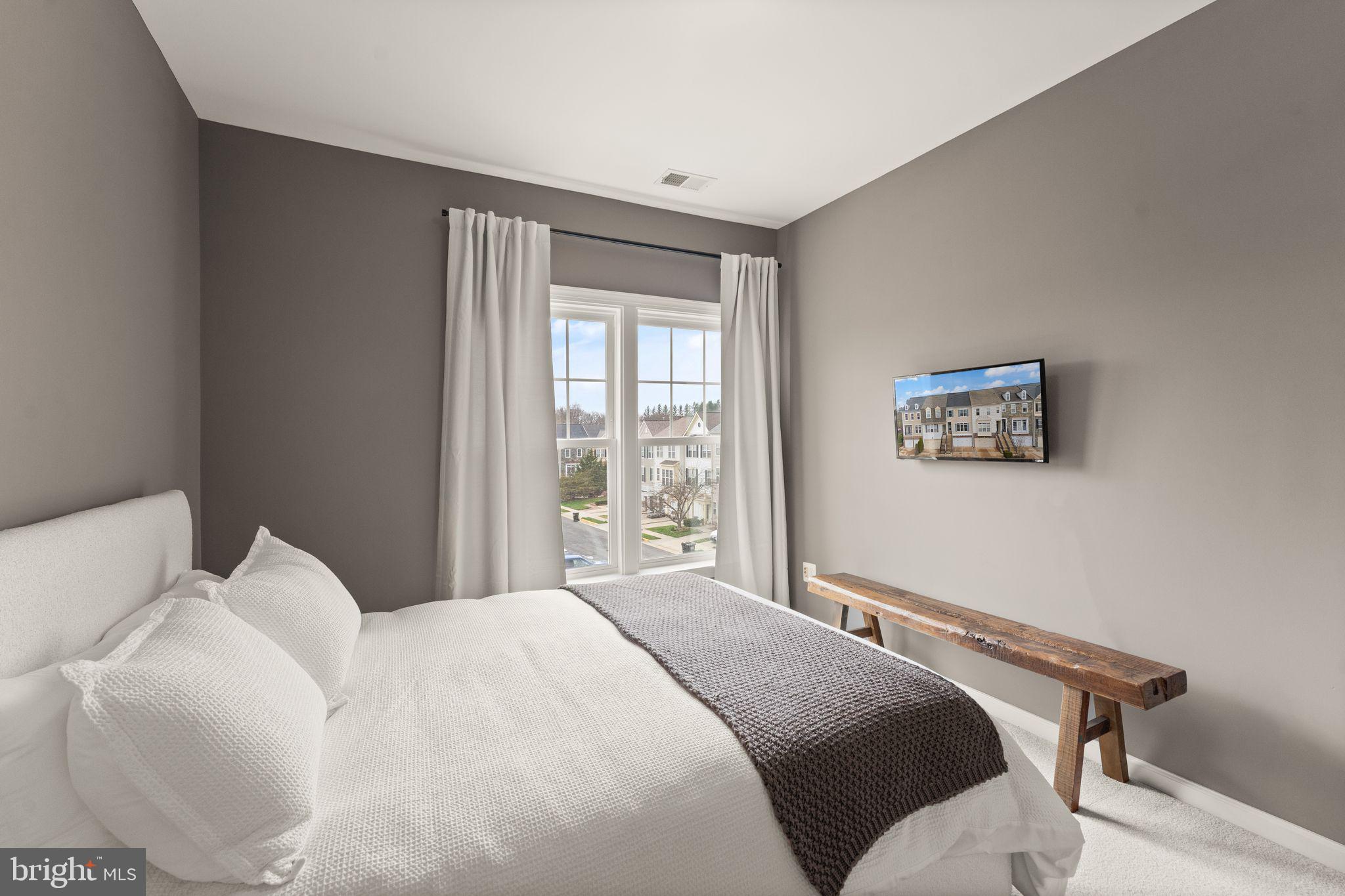 18168 Mill House Square Leesburg, VA 20176 - Photo 30 of 60 a bedroom with a bed and a window