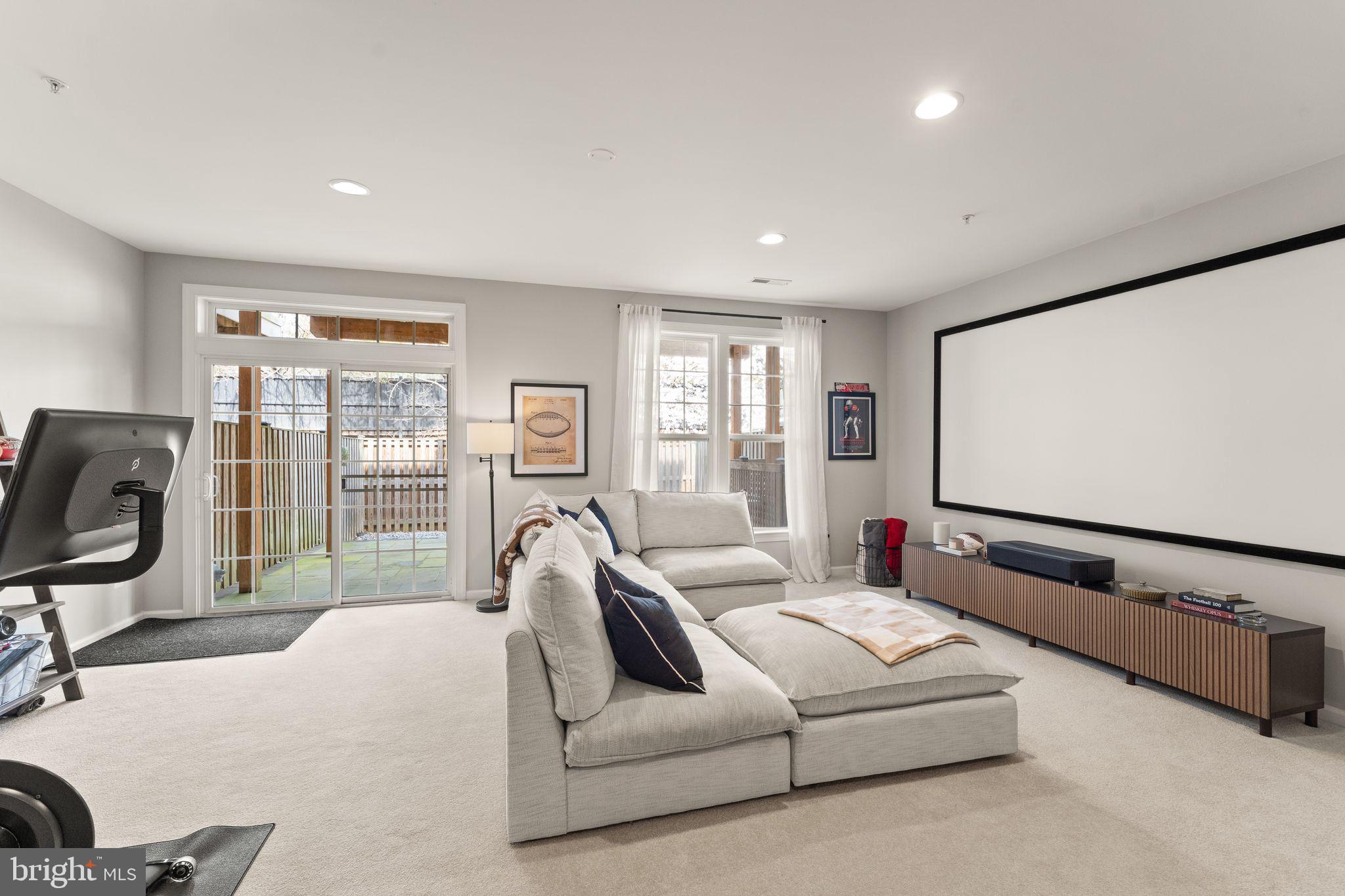 18168 Mill House Square Leesburg, VA 20176 - Photo 42 of 60 a living room with furniture gym equipment and a large window