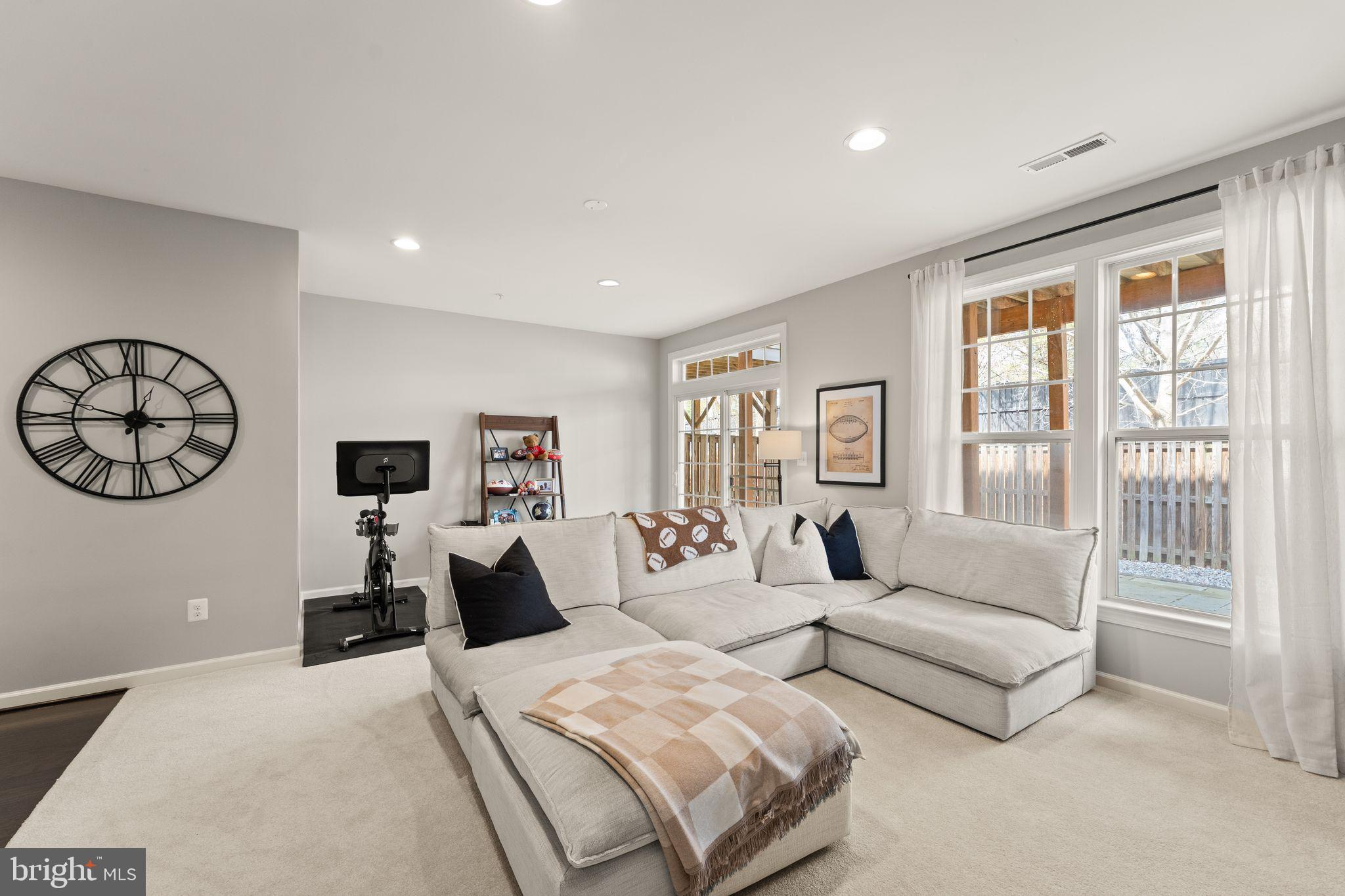 18168 Mill House Square Leesburg, VA 20176 - Photo 43 of 60 a living room with furniture a large window and a flat screen tv