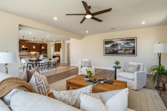 a living room with furniture and kitchen view