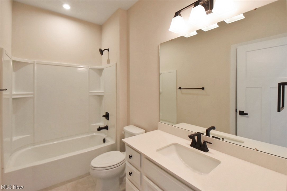 6334 Ryan Road Medina, OH 44256 - Photo 5 of 32 Full bathroom with shower / bathing tub combination, toilet, tile floors, and vanity
