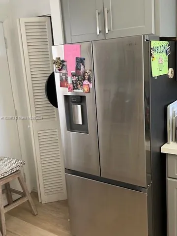 a white refrigerator freezer and a stove sitting inside of a kitchen