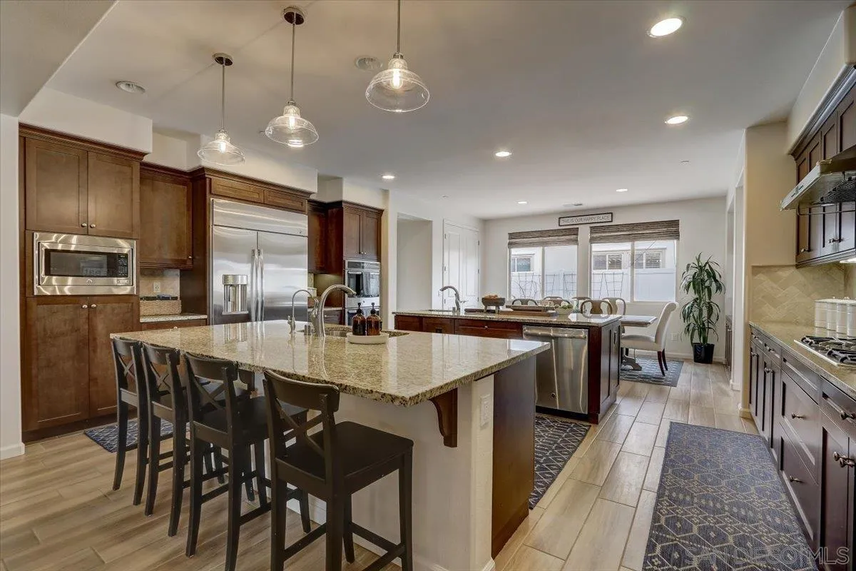 5620 Rancho Del Caballo Bonsall, CA 92003 - Photo 12 of 49 a large kitchen with a table and chairs