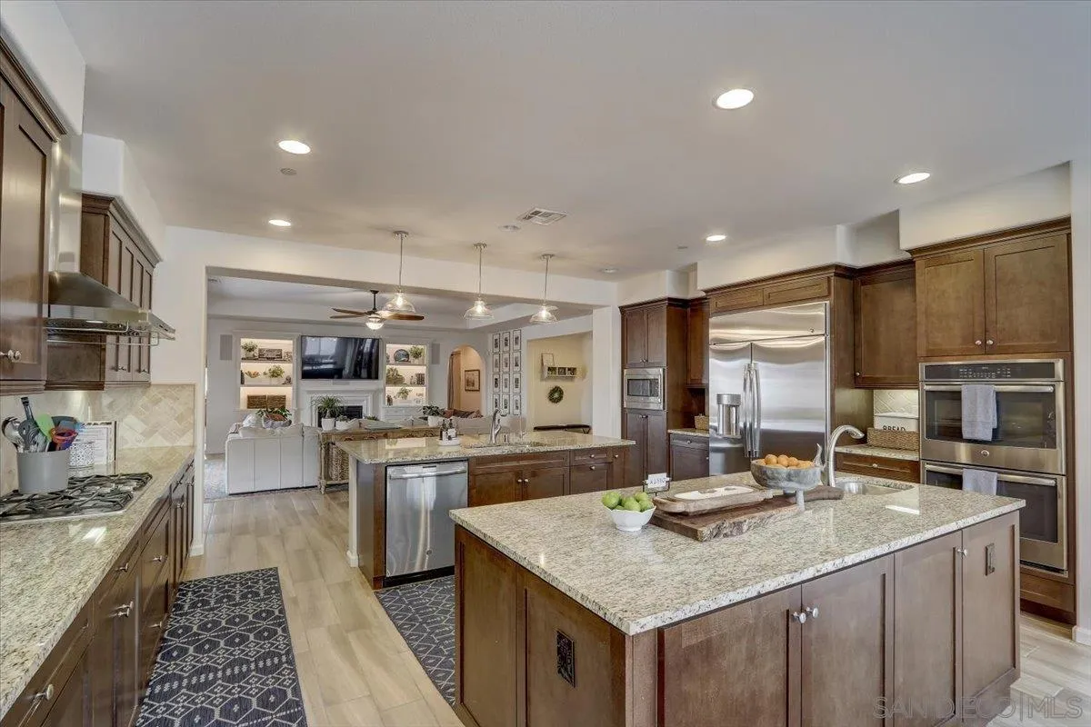 5620 Rancho Del Caballo Bonsall, CA 92003 - Photo 13 of 49 a kitchen with stainless steel appliances granite countertop a sink stove and cabinets