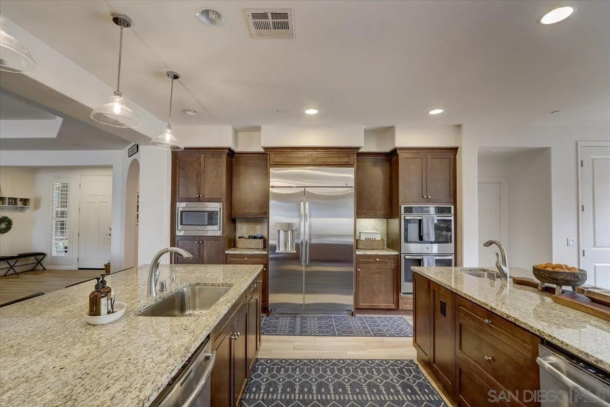 5620 Rancho Del Caballo Bonsall, CA 92003 - Photo 15 of 49 a kitchen with stainless steel appliances granite countertop a sink a stove and a refrigerator