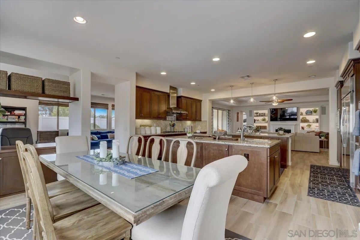 5620 Rancho Del Caballo Bonsall, CA 92003 - Photo 19 of 49 a dining room with stainless steel appliances furniture a rug and a view