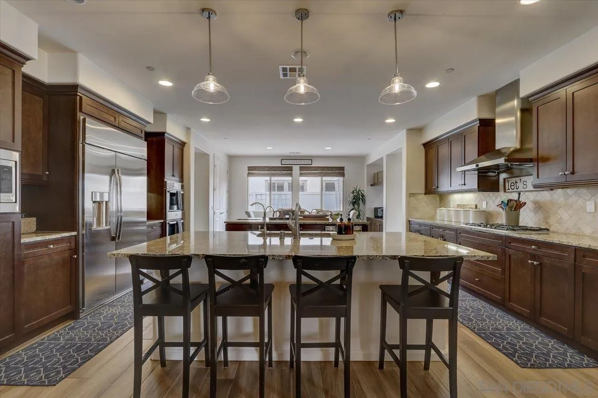 5620 Rancho Del Caballo Bonsall, CA 92003 - Photo 2 of 49 a large kitchen with a table and chairs