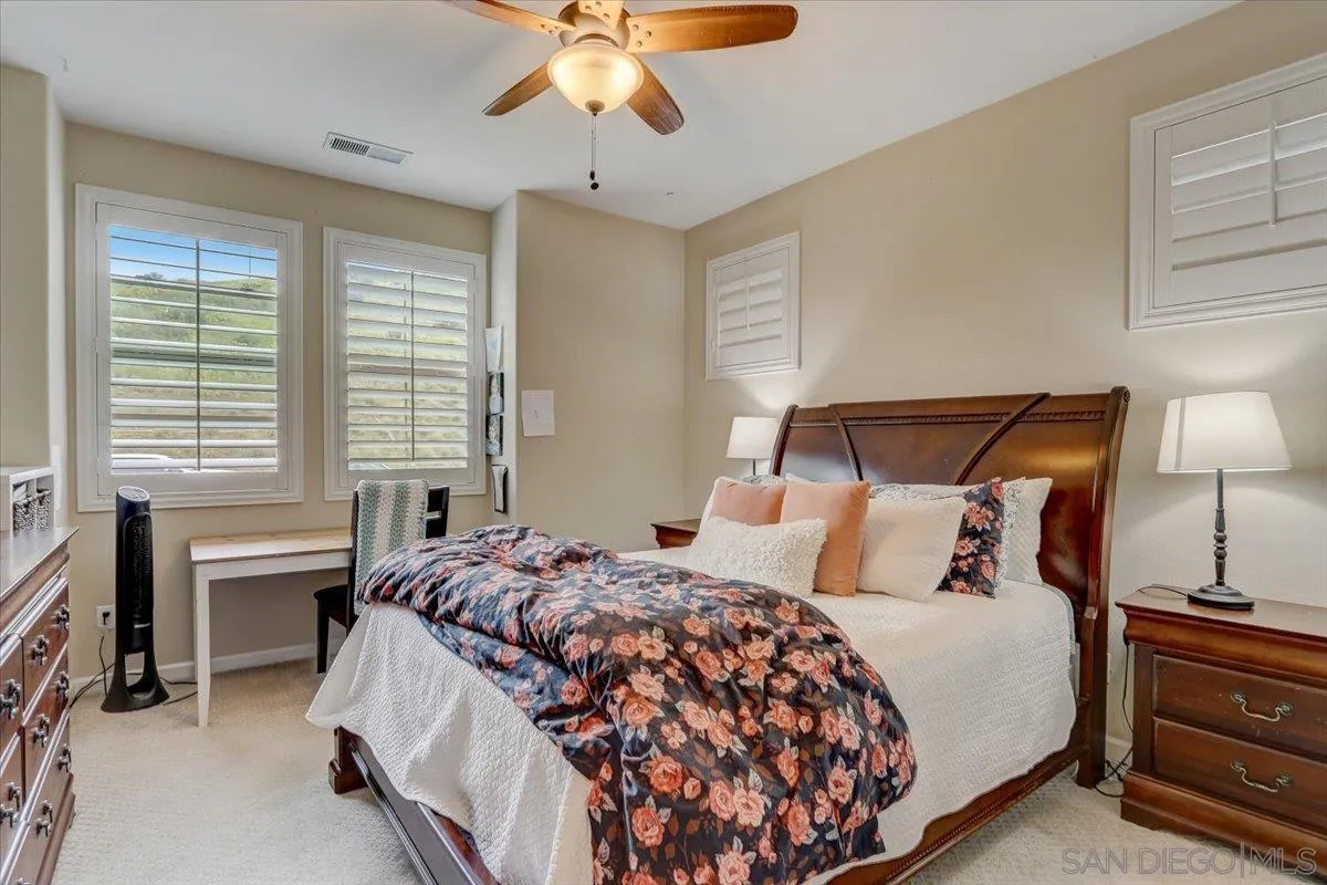 5620 Rancho Del Caballo Bonsall, CA 92003 - Photo 29 of 49 a bedroom with a bed and a chandelier