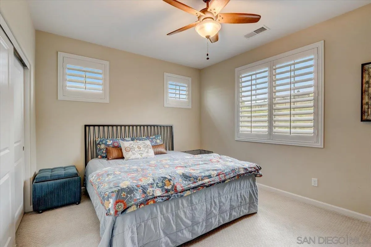 5620 Rancho Del Caballo Bonsall, CA 92003 - Photo 30 of 49 a bedroom with a large bed and a window