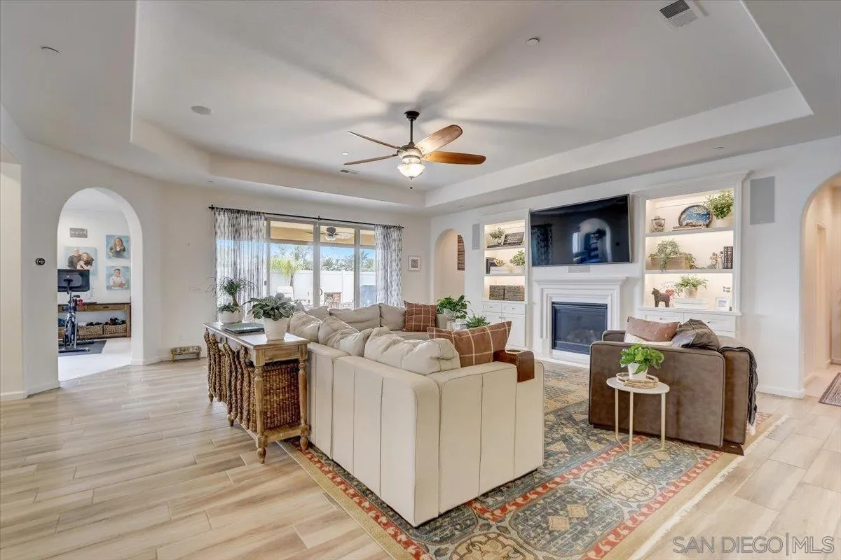 5620 Rancho Del Caballo Bonsall, CA 92003 - Photo 3 of 49 a living room with furniture a fireplace and a flat screen tv