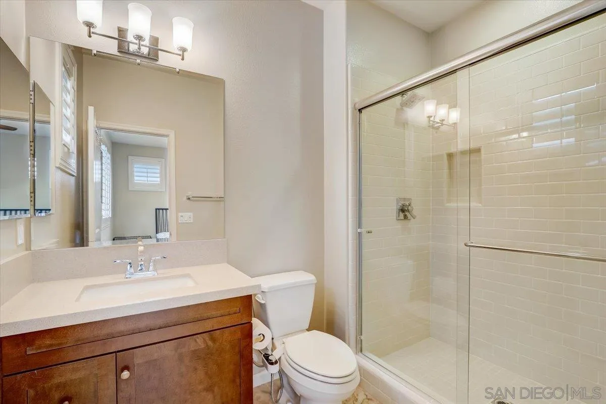 5620 Rancho Del Caballo Bonsall, CA 92003 - Photo 32 of 49 a bathroom with a sink toilet vanity and shower