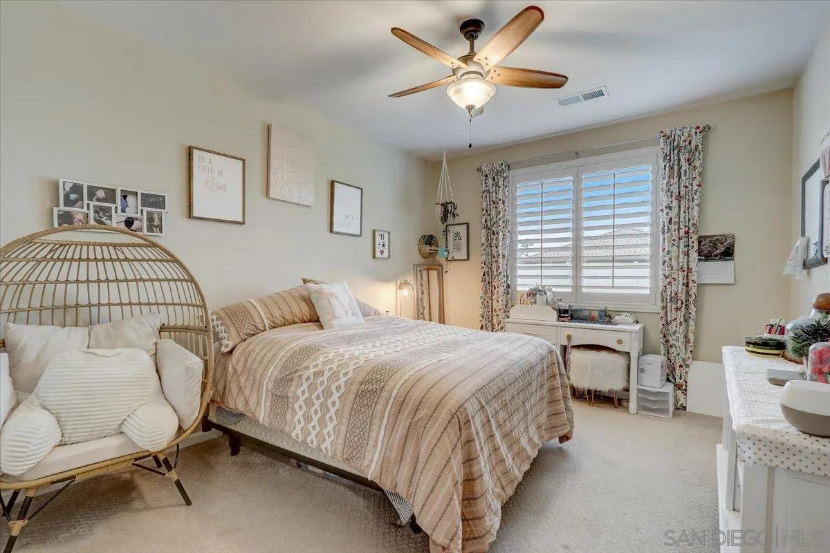 5620 Rancho Del Caballo Bonsall, CA 92003 - Photo 34 of 49 a bedroom with a bed and a chandelier
