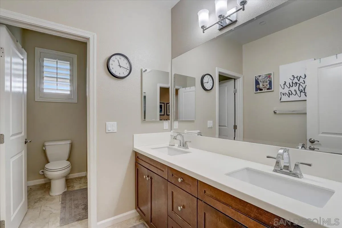 5620 Rancho Del Caballo Bonsall, CA 92003 - Photo 35 of 49 a spacious bathroom with a granite countertop sink a toilet and a mirror