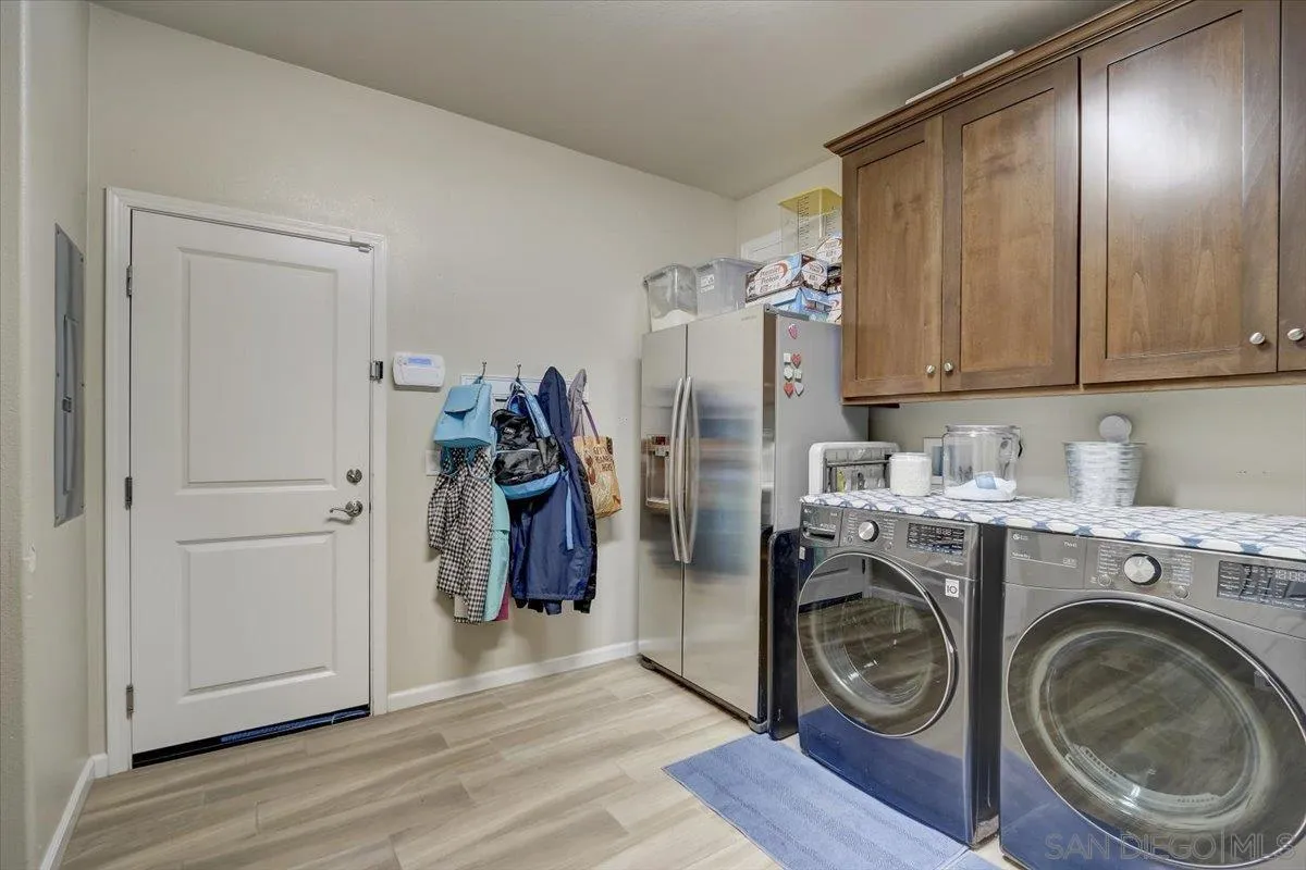 5620 Rancho Del Caballo Bonsall, CA 92003 - Photo 37 of 49 a view of a storage and utility room with washer and dryer