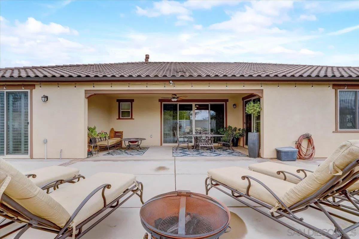 5620 Rancho Del Caballo Bonsall, CA 92003 - Photo 41 of 49 a roof deck with table and chairs a barbeque