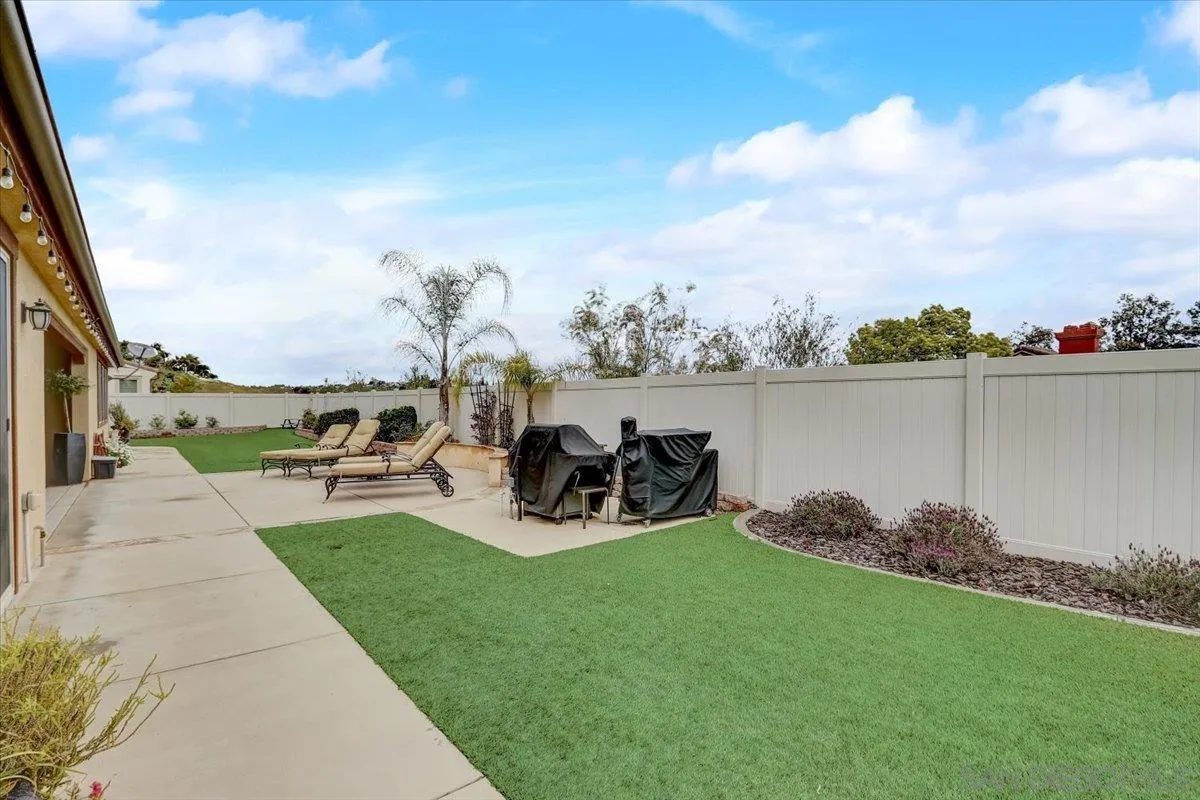 5620 Rancho Del Caballo Bonsall, CA 92003 - Photo 45 of 49 a view of a backyard with couches plants and large trees