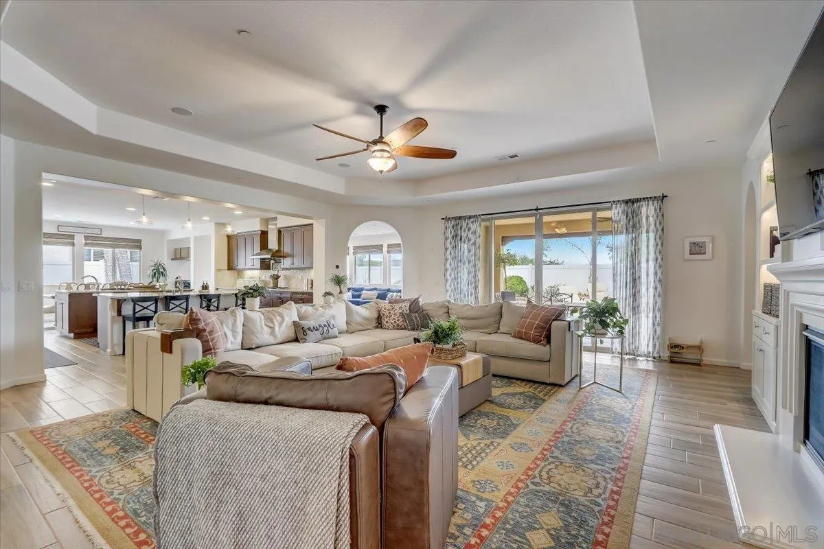 5620 Rancho Del Caballo Bonsall, CA 92003 - Photo 9 of 49 a living room with furniture a fireplace and a chandelier
